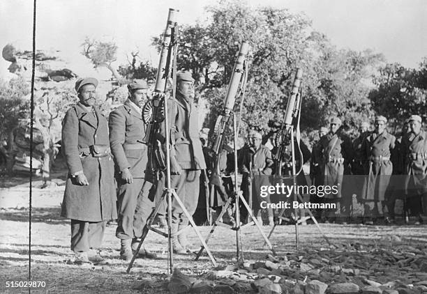 Members of Algeria's 30,000 man National Liberation Army stand at attention before their World War II surplus Lewis machine guns. The ALN was formed...