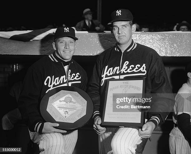 Mickey Mantle, left, star center fielder of the New York Yankees and pitcher Don Larsen, also of the Yankees, are shown holding their awards they...