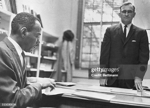 James Meredith registers for classes at the University of Mississippi, October 1, as some 1,400 US Marshals and federal troops stand guard on the...