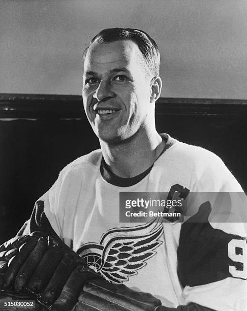Gordon Howe, of the Detroit Redwings, is shown smiling in his uniform. Head and shoulders photograph.