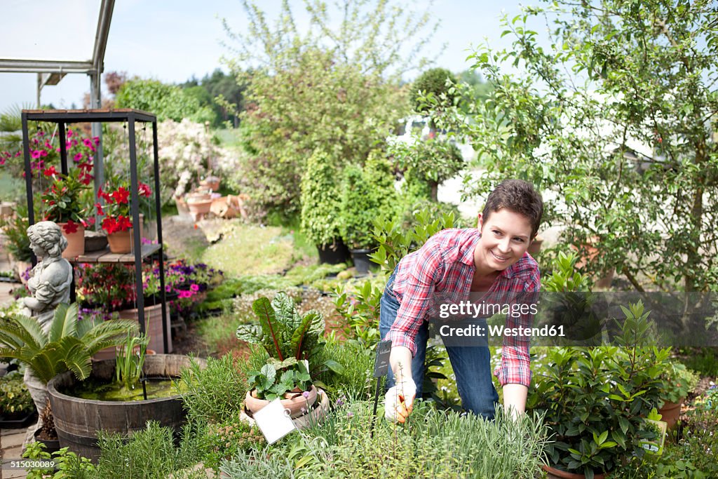 Portrait of female gardener working in garden centre