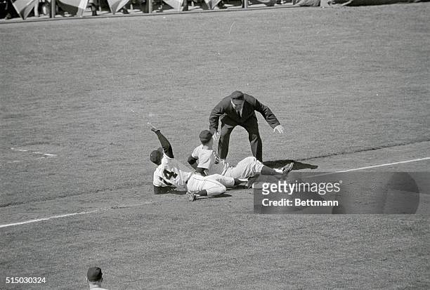 New York Yankee pitcher Whitey Ford, threw to third baseman Cletis Boyer in pickoff attempt on Willie Mays of the San Francisco Giants in the third...