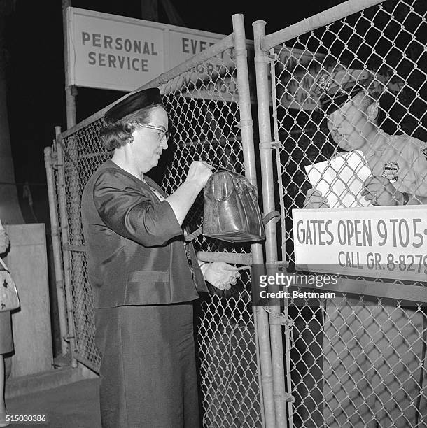 Guard at the Westwood Village Mortuary checks the name of Mrs. Inez Nelson for admittance to the mortuary where the body of actress Marilyn Monroe is...