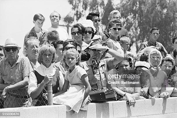 People watch - from a distance - the funeral of film star Marilyn Monroe.