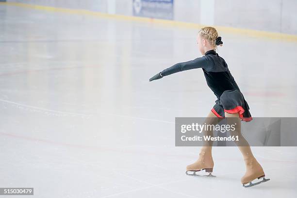 young female figure skater moving on ice rink at competition - figure skating child stock pictures, royalty-free photos & images