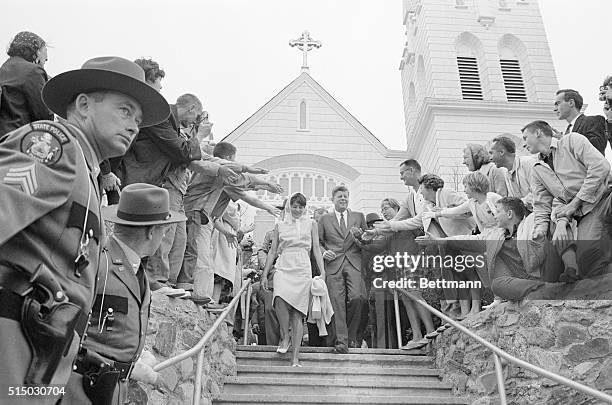 President Kennedy walks down the steps leading away from the Church of Our Lady Queen of Peace with his sister, Mrs. Patricia Lawford, after...