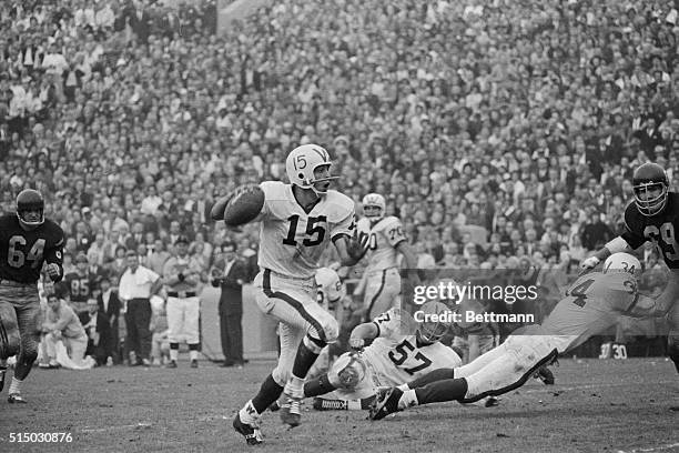 The Rose Bowl Game played here was between Wisconsin and USC. Ron Vanderkelen, a Wisconsin quarterback, #15, is shown about to pass during the game....