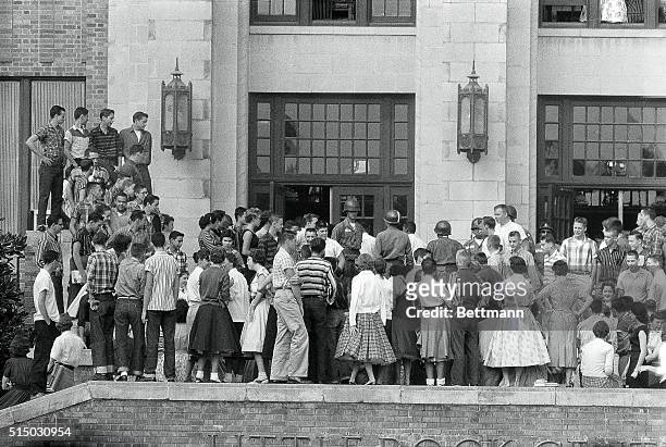 White students of Central High School are shown on the wall and along the stairway leading to the entrance as they watched Federal Troops escort...