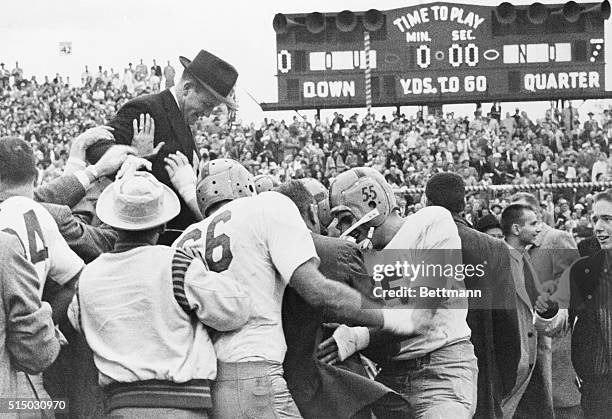 Notre Dame football players join students in giving Coach Terry Brennan a ride on their shoulders after the Irish scored the upset of the year,...