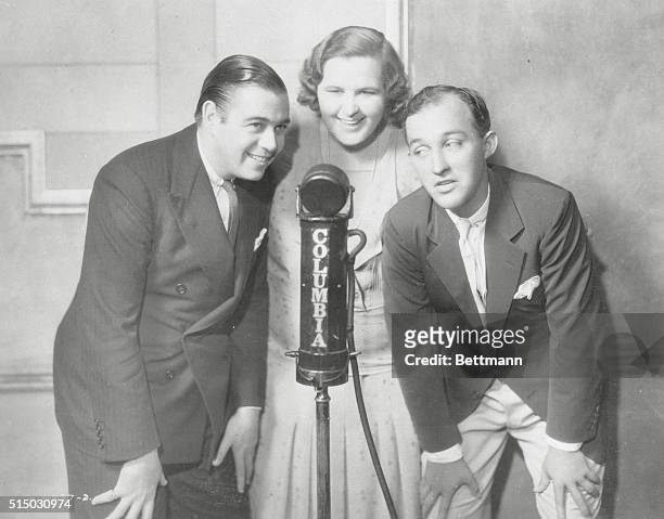 Kate Smith known as "The first Lady of Radio" is pictured around microphone when actors Bing Crosby and Morton Downey came to visit the radio station.