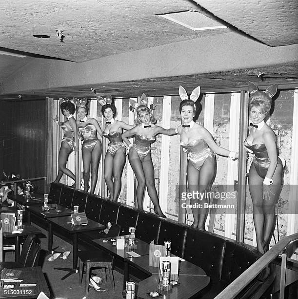 Decorating the still furnished wall of the new Playboy Club in New York City are the shapely hostesses. The girls dressed in "Bunnie" costumes, ,...