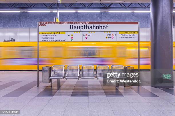 germany, berlin, modern architecture of subway station hauptbahnhof, central station, with moving underground train - u bahnstation stock-fotos und bilder