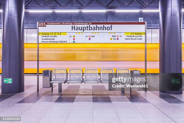 germany, berlin, modern architecture of subway station hauptbahnhof, central station, with moving underground train - u bahnstation stock-fotos und bilder