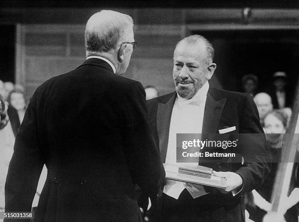 Stockholm, Sweden: Bearded American novelist John Steinbeck, , receives his literary award from Sweden's King Gustav Adolf in Stockholm's Concert...