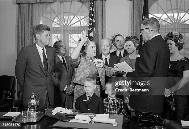 Takes oath. Washington: As President Kennedy looks on, Mrs. Kathryn Granahan is sworn in as new Treasurer of the U.S. During a White House ceremony...