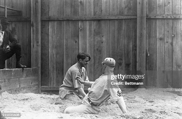 Branch Rickey, manager and President of the St. Louis Cardinals, teaching the team rookies the art of base-sliding at the Cardinal Camp Louisiana.