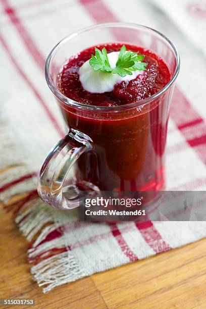 beet and tomato gazpacho with a dollop of soy yogurt as garnish with a parsley leaf - gazpacho stock pictures, royalty-free photos & images