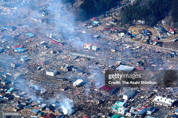 In this aerial image, a stranded fish boat the Dai 18 Kyotoku Maru among debris after the tsunami followed by the magnitude 9.0 strong earthquake at...