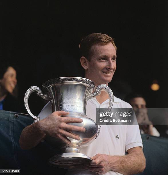 Australian tennis player Rod Laver holds the U.S. Open trophy after defeating fellow countryman Roy Emerson, 6-2, 6-4, 5-7, 6-4, in the men's singles...