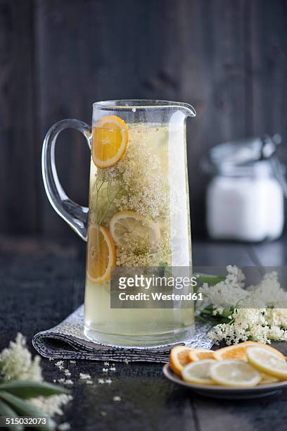 jar of home-made elderflower sirup with slices of orange and lemon - sugar jar stock pictures, royalty-free photos & images