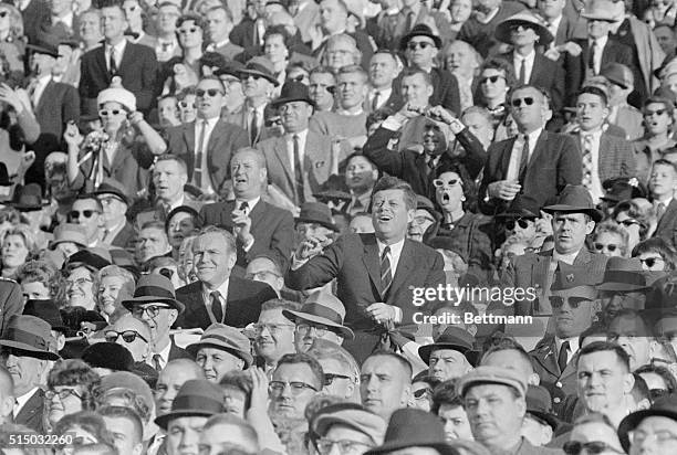 President Kennedy reacts to Army pass that was interjected by Navy's Walt Pierce and fumbled twice before he finally recovered on the Army 5-yard...