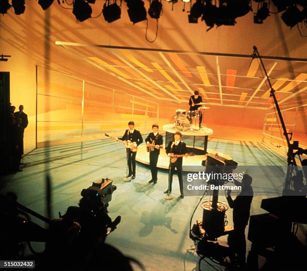 The Beatles during a performance taping for the Ed Sullivan Show in 1964.