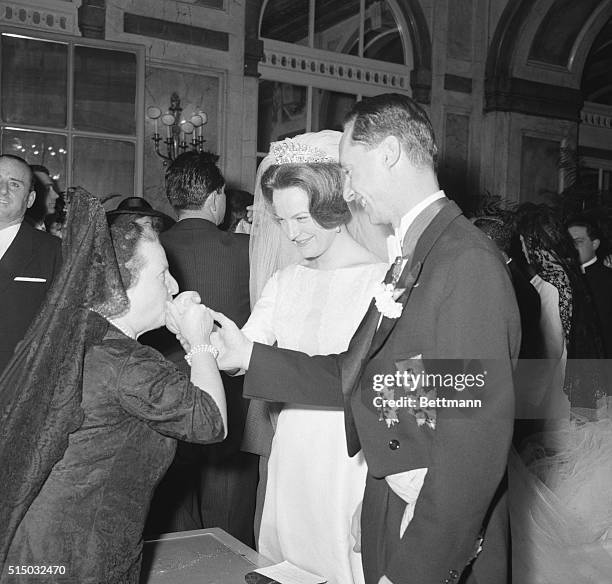 At The Reception. Rome, Italy: Unidentified Spanish lady kisses the hands of the bride and groom, Princess Irene of the Netherlands and Spanish...