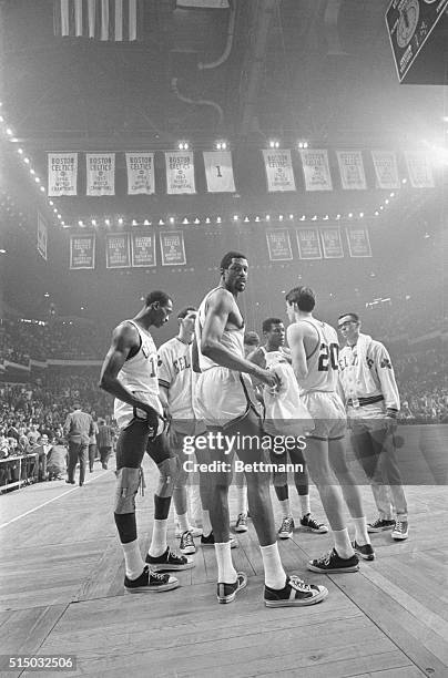 Boston Celtics basketball player Bill Russell looks at the camera during a time-out in the waning moments of the 4th playoff game with the 76ers at...