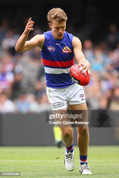 Jack Macrae of the Bulldogs kicks during the 2016 NAB Challenge AFL match between the Collingwood Magpies and the Western Bulldogs at Etihad Stadium...