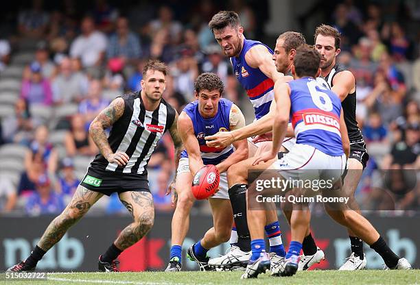 Tom Liberatore of the Bulldogs handballs during the 2016 NAB Challenge AFL match between the Collingwood Magpies and the Western Bulldogs at Etihad...