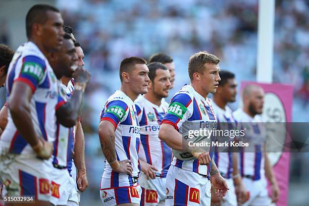 Trent Hodkinson of the Knights and his team mates look dejected after a Rabbitohs try during the round two NRL match between the South Sydney...