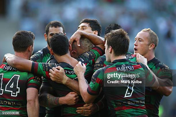 Aaron Gray of the Rabbitohs celebrates with his team mates after scoring a try during the round two NRL match between the South Sydney Rabbitohs and...