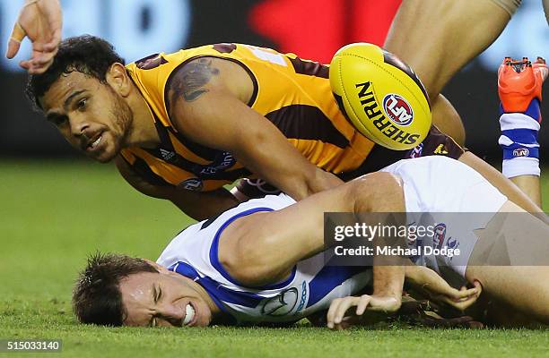 Cyril Rioli of the Hawks tackles Sam Wright of the Kangaroos during the NAB CHallenge AFL match between the Hawthorn Hawks and the North Melbourne...