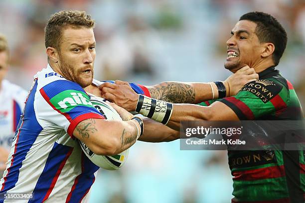 Korbin Sims of the Knights fends off Cody Walker of the Rabbitohs during the round two NRL match between the South Sydney Rabbitohs and the Newcastle...