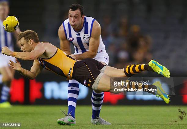 Todd Goldstein of the Kangaroos tackles Sam Mitchell of the Hawks during the NAB CHallenge AFL match between the Hawthorn Hawks and the North...