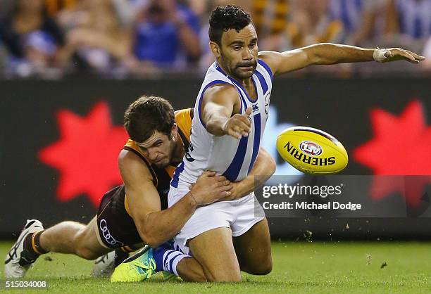 Ben Stratton of the Hawks tackles Lindsay Thomas of the Kangaroos during the NAB CHallenge AFL match between the Hawthorn Hawks and the North...