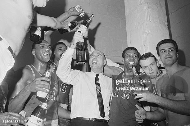 Boston: A happy 76ers basketball team celebrates their winning the NBA Eastern Division Championship, downing Celtics in single overtime, 115-113,...