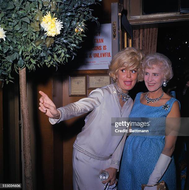 New York, New York: Time magazine's 40th anniversary dinner. Carol Channing , hugs Clare Boothe Luce.