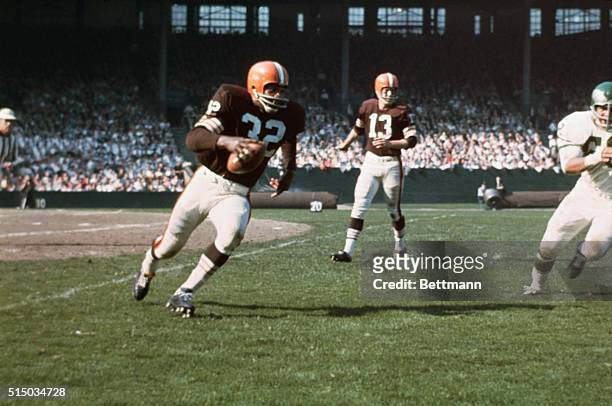 Jim Brown has just taken hand off from Quarterback Frank Ryan in game against the Philadelphia Eagles.