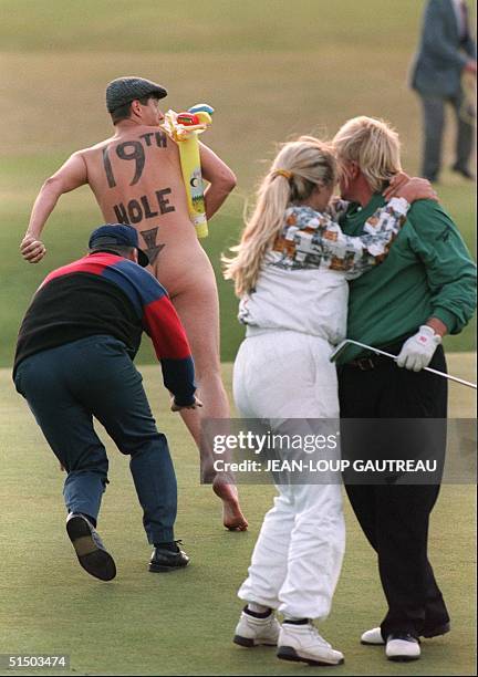 Streaker runs onto the 18th green as John Daly and his wife Paulette celebrate after Daly beat Costanino Rocca of Italy in a play-off to take British...