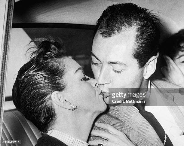 International singing star Judy Garland kisses her American actor friend and "escort" Mark Herron in a car at the airport here June 30th. The couple,...
