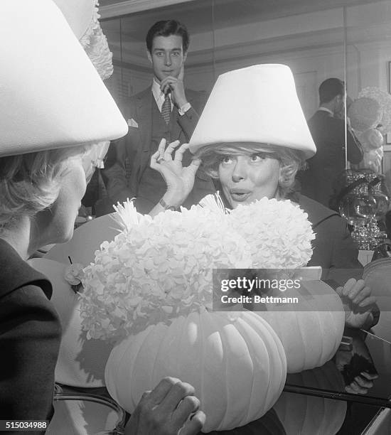 New York: Hello Dolly! ...Carol is visibly delighted by this lovely white Courreges hat, one of the fresh imports from Paris which she examined...