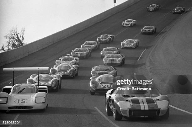 Leading the pack at the start of the 24-hour Continental race here February 4th are Phil Hill in Chaparral and A.J. Foyt in a Ford Mark II. The...