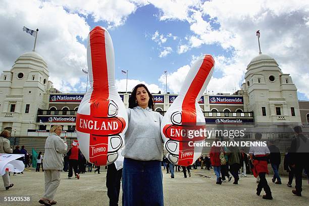 An England supporter with inflatable thumbs outside the famous twin towers at Wembley Stadium in London 27 May 2000. The stadium is to be demolished...