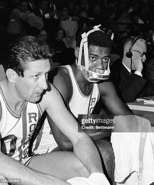 Oscar Robertson, of Cincinnati Royals, played with a face guard during the game against Boston here 2/7. Robertson sustained an injury requiring 6...