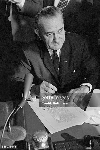 The Bill is Signed in Washington, DC: The hands of President Lyndon Johnson rest on the signed Civil Rights Bill after the chief executive signed the...