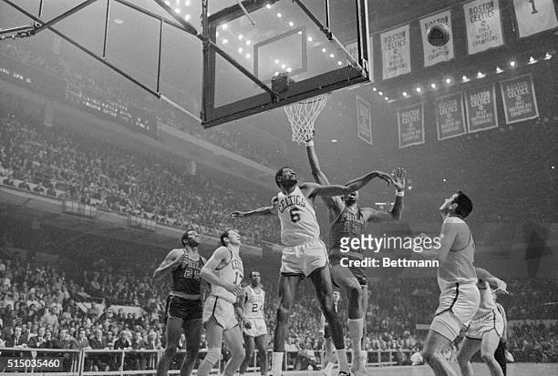 Boston: Celtics' Bill Russell and 76ers Wilt Chamberlain battles for the ball as Celtics' John Havlicek looks on, 2nd period action, fourth game NBA...