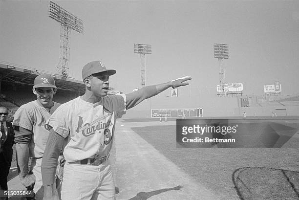 Boston: Orlando Cepeda, Cardinal candidate for MVP in National League, makes like Babe Ruth as he points to where he intends to blast hits against...