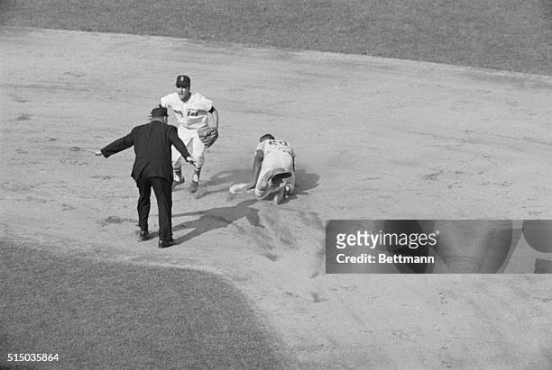 St. Louis Cardinals baseball player Lou Brock steals second base before Red Sox shortstop Rico Petrocelli can tag him out. Umpire Frank Umont makes...
