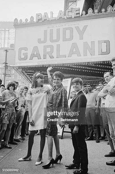 To the Palace. The famed singer Judy Garland stands with her children Lorna and Joey Luft outside The Palace Theatre in New York where she played two...